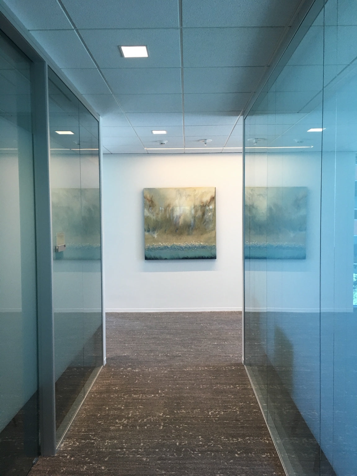 An atmospheric abstract painting framed by a glass-walled corridor.