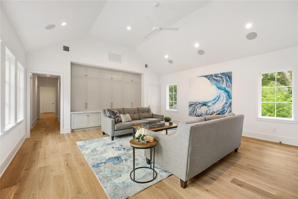 Large blue abstract painting in a bright residential living room.