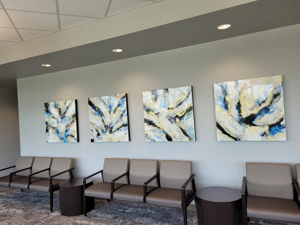 Four blue and gold abstract paintings above waiting-area seating.