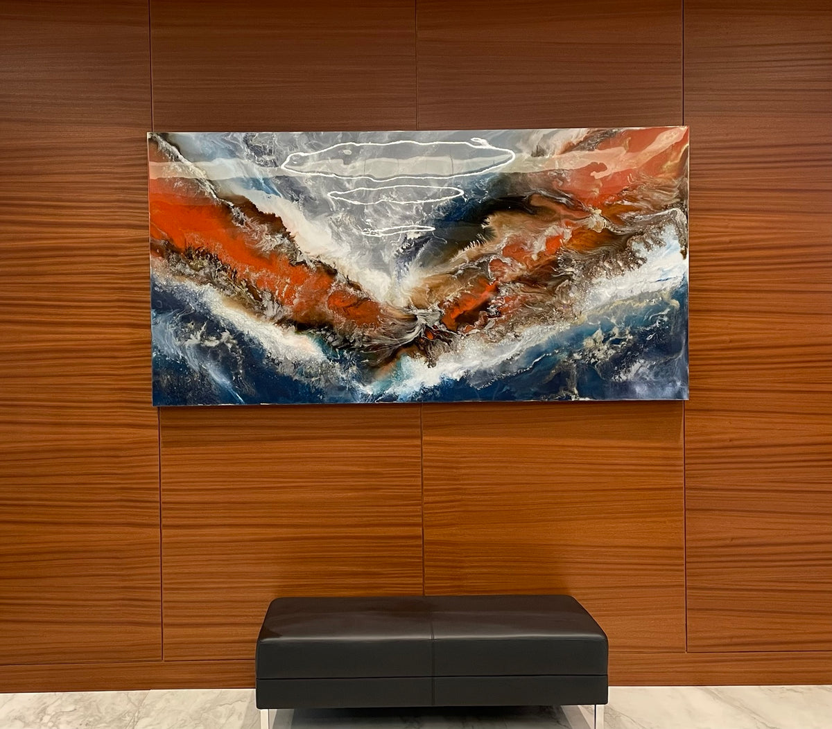 Orange and blue abstract painting on a wood-paneled lobby wall.